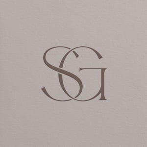 May include: A minimalist design featuring the intertwined letters "SG" in a soft brown hue. The elegant monogram is set against a neutral, textured background, creating a sophisticated and understated aesthetic.