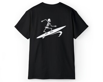 May include: Black t-shirt with a white graphic of a skeleton surfing on a wave.