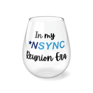 May include: A clear glass wine glass with the text "In my *NSYNC Reunion Era" printed on it in black with a blue star and blue lettering for "NSYNC".