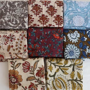 Może przedstawiać: Dziewięć kwadratowych kawałków tkaniny z różnymi wzorami kwiatowymi. Kwadraty są w różnych kolorach, w tym niebieskim, brązowym, czerwonym i białym.