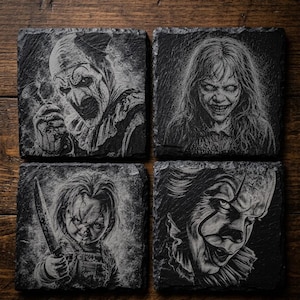 May include: A set of four square black slate coasters featuring detailed white laser-engraved portraits of horror movie characters. The designs include Art the Clown, Regan MacNeil, Chucky, and Pennywise, each rendered with high-contrast shading.