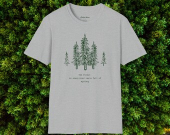 May include: A heather gray t-shirt featuring a forest graphic in green. The design includes several stylized pine trees and the text "The Forest, An unexplored realm full of mystery". The shirt has a crew neck and short sleeves.