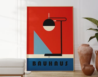 May include: A red, blue, and white poster with a black and white geometric lamp design. The poster has the word "BAUHAUS" printed in black letters on a blue background.
