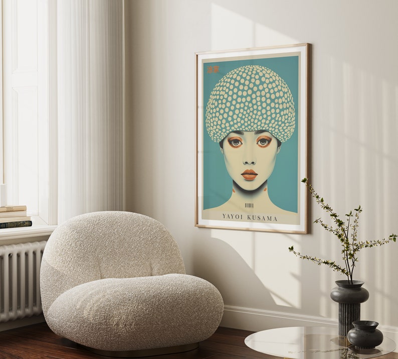 May include: A framed art print depicting a woman with a polka-dot hat. The artwork has a teal background and a light wood frame. The text "Yayoi Kusama" is visible.