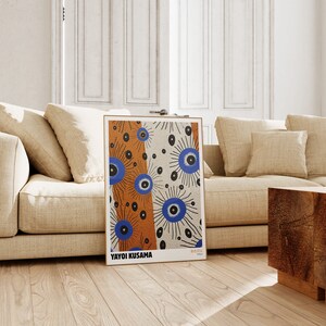 May include: A poster featuring a colorful abstract design with blue, orange, and black circles. The poster is titled "Yayoi Kusama" and has the text "無限の網" in Japanese.