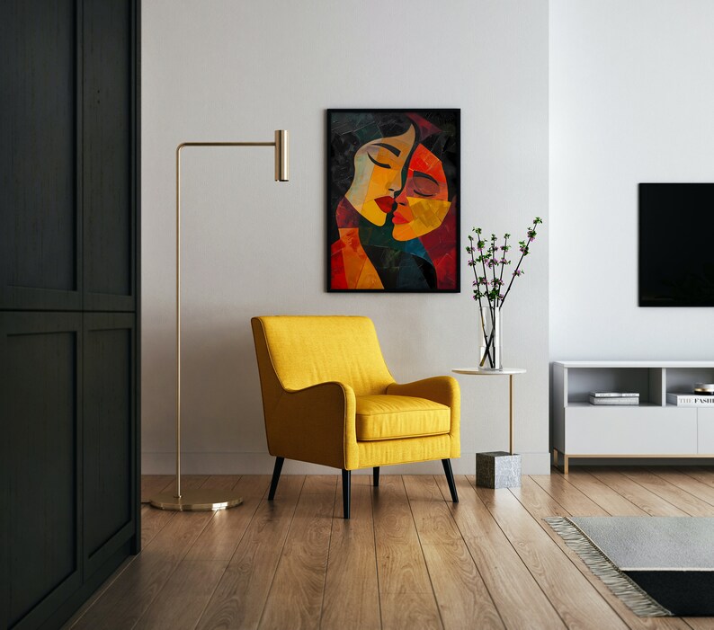 May include: A yellow armchair sits in a living room with a black and white abstract painting of two women's faces on the wall. A gold floor lamp stands next to the chair, and a small table with a vase of pink flowers sits in front of the chair.