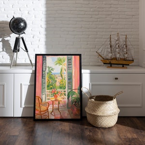 May include: A framed painting depicting a view from a window with pink curtains. The window looks out onto a balcony with a chair, a small table, and potted plants. The view beyond the balcony shows a cityscape with palm trees and a blue sky.