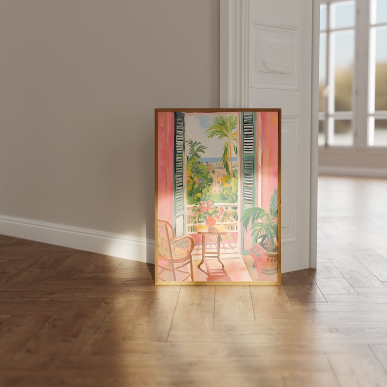 May include: A framed painting of a window with a view of a city and palm trees. The window is open and there is a chair and a small table in the room. The painting is in a gold frame and has a pink background.