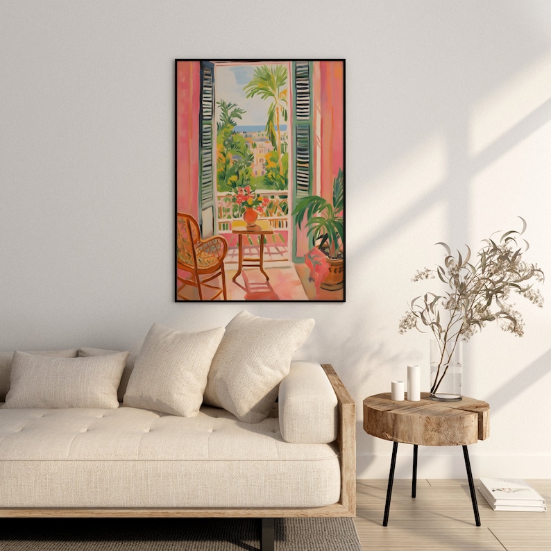May include: A painting of a window with pink curtains and green shutters, looking out onto a balcony with a table and chair. The balcony overlooks a city with palm trees and a blue sky.