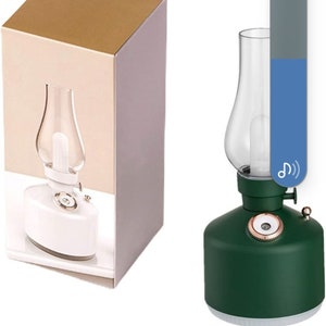 May include: A green and white oil lamp shaped nightlight with a glass shade. The lamp has a USB charging cable, two white diffuser sticks, and a box with a white oil lamp design on it.