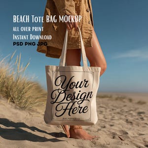 May include: A beige tote bag with the text "Your Design Here" in black script. The bag is held by a person on a sandy beach. The words "Beach Tote Bag Mockup", "All Over Print", "Instant Download", and "PSD PNG JPG" are printed on the top left.