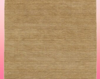 May include: A solid brown rug with a subtle texture. The rug has a fringed edge.