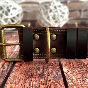 Handcrafted dark brown leather dog collar featuring double stitching, antique brass hardware, and a durable three-layer construction.