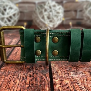 Green leather dog collar made from full-grain leather with reinforced stitching, brass rivets, and a solid brass D-ring.