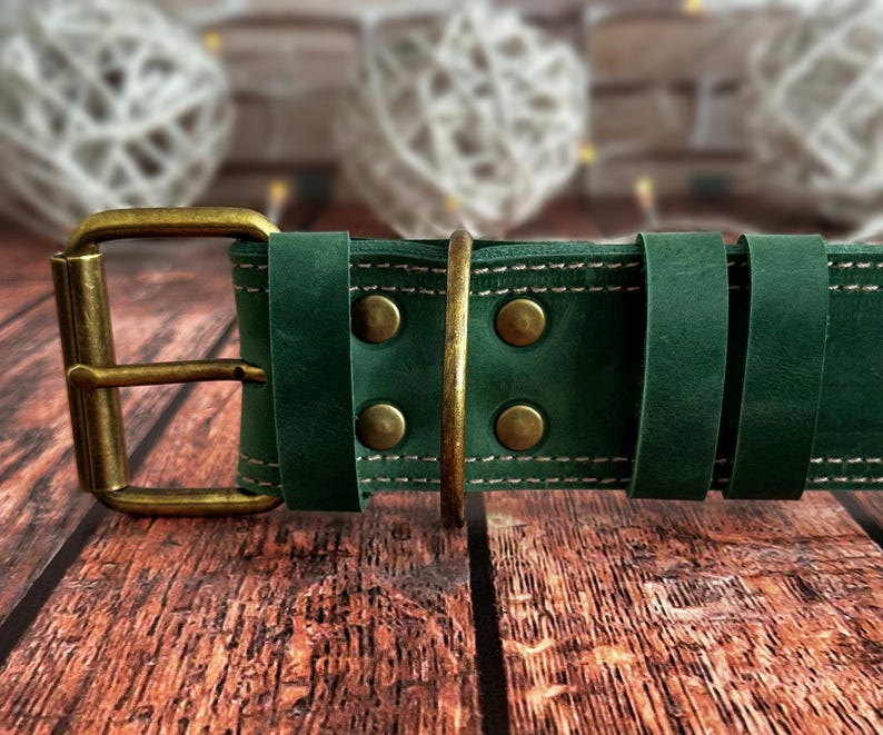 Green leather dog collar made from full-grain leather with reinforced stitching, brass rivets, and a solid brass D-ring.