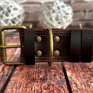 Handcrafted dark brown leather dog collar featuring double stitching, antique brass hardware, and a durable three-layer construction.
