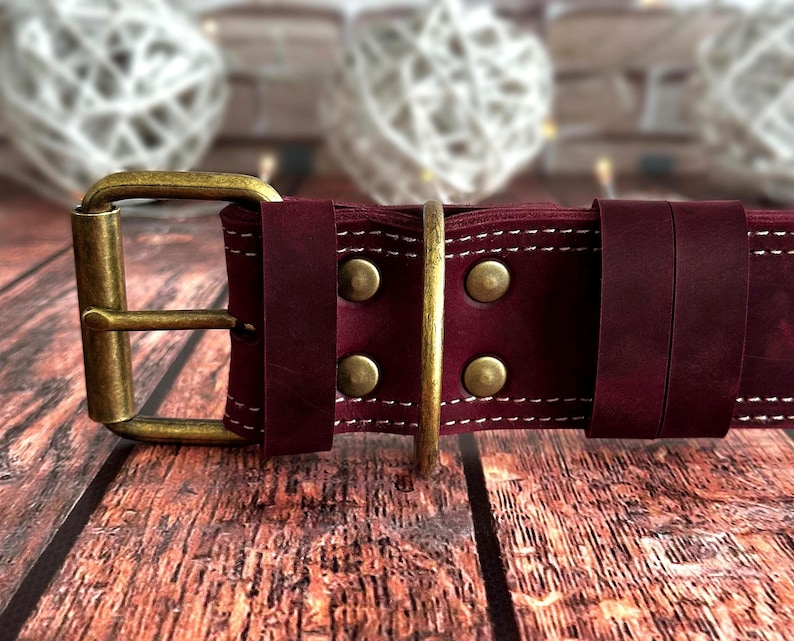 Wide burgundy leather dog collar with reinforced stitching, antique brass buckle, and heavy-duty D-ring for leash attachment.