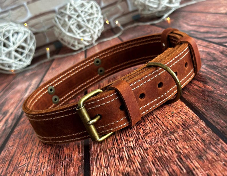 Full-grain cognac leather dog collar with antique brass buckle and sturdy D-ring for everyday use.