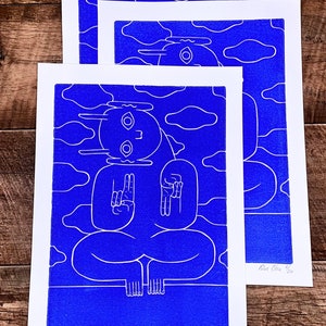 A captivating blue character emerges from a textured blue background in a linocut print. Intricate lines define its mystical pose, contrasting subtly against varying shades of blue, creating an enigmatic, mesmerizing effect.