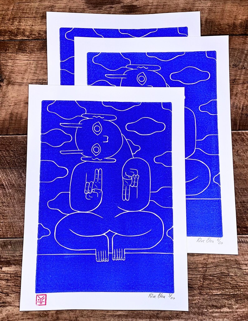 A captivating blue character emerges from a textured blue background in a linocut print. Intricate lines define its mystical pose, contrasting subtly against varying shades of blue, creating an enigmatic, mesmerizing effect.