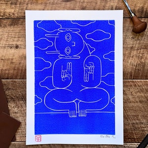 A captivating blue character emerges from a textured blue background in a linocut print. Intricate lines define its mystical pose, contrasting subtly against varying shades of blue, creating an enigmatic, mesmerizing effect.