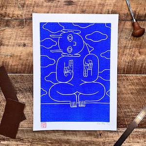 A captivating blue character emerges from a textured blue background in a linocut print. Intricate lines define its mystical pose, contrasting subtly against varying shades of blue, creating an enigmatic, mesmerizing effect.