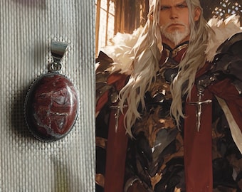 May include: A silver pendant with a red and white stone. The stone has a swirling pattern. The pendant is on a white background.