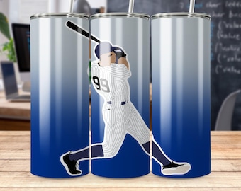 May include: A tumbler with a blue and white gradient background featuring a baseball player in a pinstripe uniform swinging a bat. The player's jersey has the number 99. The tumbler is designed for cold beverages.