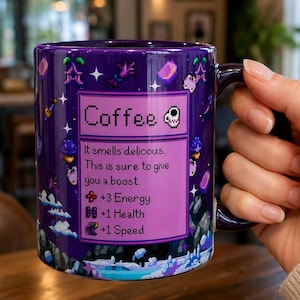 May include: A purple ceramic mug featuring a pixel art design of a game item box labelled Coffee. The text reads: It smells delicous. This is sure to give you a boost. +3 Energy, +1 Health, +1 Speed. The background displays various pixelated icons.