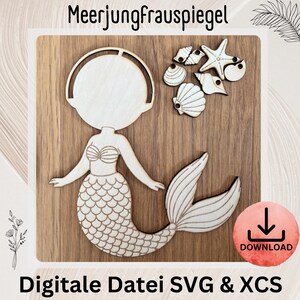 May include: Wooden mermaid and seashell cutouts on a wooden background. The mermaid has a detailed tail and seashell bra. The image includes the text "Meerjungfrauspiegel" and "Digitale Datei SVG & XCS" with a download icon.