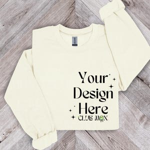 Puede incluir: Una camiseta de manga larga de color crema con el texto "Your Design Here" y "CLUB MOX" impreso en la parte delantera.