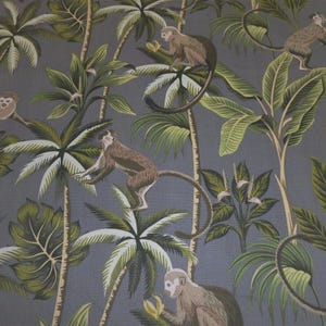 May include: Textile featuring a repeating pattern of monkeys in a jungle scene. Brown monkeys with light faces and tails are set amongst green palm leaves and trees against a grey backdrop. The design has a tropical theme.