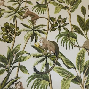 May include: A white fabric with a tropical print featuring green palm trees and monkeys. The monkeys are brown and have long tails.