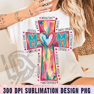 May include: A white t-shirt with a colorful cross design featuring the word "MOM" and positive affirmations like "worthy", "blessed", "amazing", "capable", "unstoppable", "fearless", "chosen", "beautiful", "loved", "important", "strong", "always enough", "never alone", "victorious".