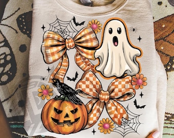 May include: A beige sweatshirt featuring a Halloween-themed design. The design includes a jack-o'-lantern, a ghost, bows, flowers, bats, and spiderwebs. The text "300 DPI SUBLIMATION DESIGN PNG" is at the bottom.