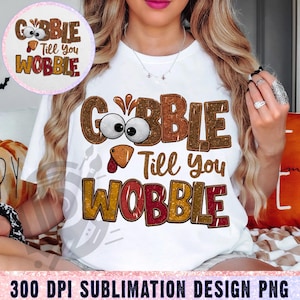 Puede incluir: Camiseta blanca con un diseño de Acción de Gracias con un pavo de dibujos animados con el texto "Gobble Till You Wobble" en una fuente brillante.