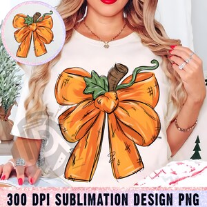 May include: A cream-coloured t-shirt with a large orange bow design, stem, and green leaf. The bow has a textured look with black outlines. The text "300 DPI SUBLIMATION DESIGN PNG" is at the bottom of the image.