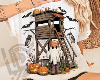 May include: White t-shirt featuring a Halloween-themed design. The graphic includes a wooden lookout tower, bats, pumpkins, and a ghost wearing a "Candy Hunter" hat. Two ducks hang from the tower. The design is a PNG file.