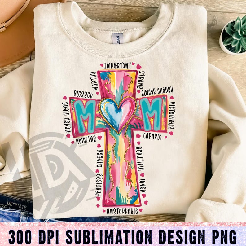 May include: A sublimation design featuring a colorful cross with the word "MOM" in the center. The cross is surrounded by words describing a mother, such as "blessed", "worthy", "strong", "always enough", "victorious", "capable", "amazing", "fearless", "chosen", "beautiful", "loved", and "unstoppable".