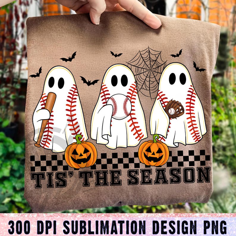 May include: Brown fabric with a Halloween-themed design. Features three baseball-themed ghosts, bats, a spiderweb, and jack-o'-lanterns. The text "TIS' THE SEASON" is displayed below the ghosts. The design is labeled as a 300 DPI sublimation design PNG.