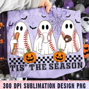 May include: A light purple Halloween-themed design featuring three baseball-shaped ghosts with baseball bats, balls, and gloves. The ghosts are positioned above orange jack-o'-lanterns, with bats and a spiderweb in the background. The text "TIS' THE SEASON" is displayed at the bottom.