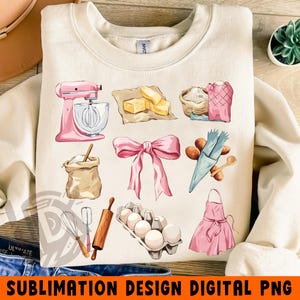 May include: Cream-colored sweatshirt featuring a collection of baking-themed illustrations. Includes a pink stand mixer, butter, flour, a pink bow, eggs, and an apron. The text "SUBLIMATION DESIGN DIGITAL PNG" is at the bottom.