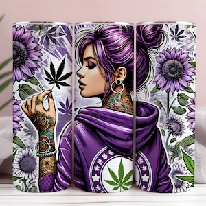 May include: A purple and green stainless steel tumbler featuring a graphic of a woman with purple hair and tattoos holding a cannabis leaf. The tumbler is decorated with sunflowers and cannabis leaves.