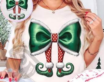 May include: A cream-colored t-shirt featuring a large green bow with white trim and red polka-dot accents. Below the bow are red and white polka-dot legs with elf shoes. The text "300 DPI SUBLIMATION DESIGN PNG" is at the bottom.