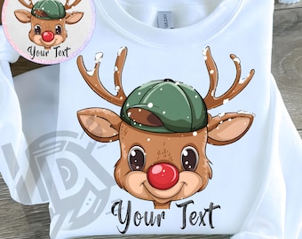 May include: A white sweatshirt featuring a graphic of a reindeer wearing a green baseball cap and sporting a bright red nose. The reindeer has brown antlers with white snow accents. The text Your Text is printed in black below the reindeer.