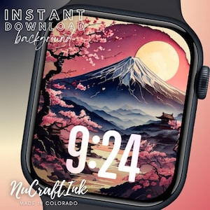 Könnte beinhalten: Ein digitales Zifferblatt mit einer rosa und blauen Berglandschaft mit einem großen Mond und Kirschblüten. Die Uhrzeit ist 9:24. Der Text "NuCraft Ink" und "MADE IN COLORADO" befindet sich am unteren Rand des Zifferblatts.