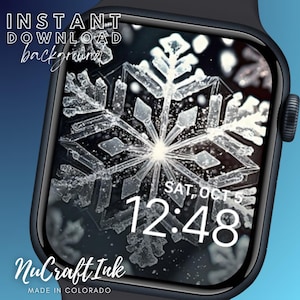 Puede incluir: Primer plano de un copo de nieve en una esfera de Apple Watch negra. La hora es 12:48 y la fecha es Sáb, 5 oct. La esfera del reloj está rodeada por una banda negra. El texto "NuCraftInk MADE IN COLORADO" está en la parte inferior de la pantalla.