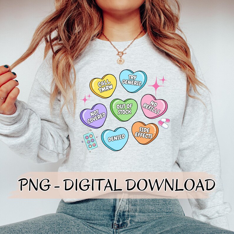 May include: A gray sweatshirt with a graphic of colorful candy hearts with phrases like "Call Tmrw", "Try Generic", "Out of Stock", "No Refills", "Not Covered", "Denied", and "Side Effects".