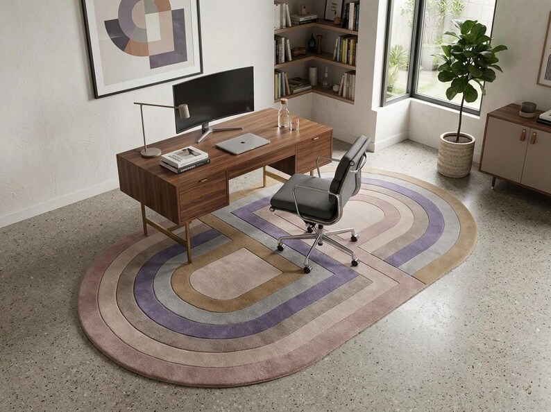Home office anchored by a modern oval area rug, carved relief and colorful area rug tones under desk