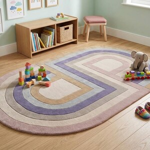 Playroom corner with toys on modern oval area rug, soft hand tufted wool, lavender mauve colorful area rug